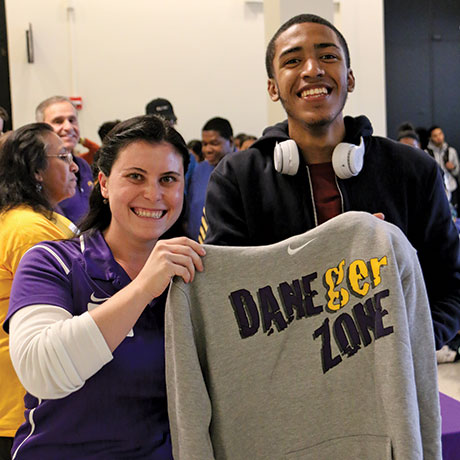 Jillian Pasco presents incoming EOP student with DangerZone hoddie