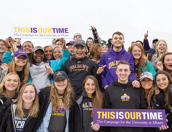 Students cheer and hold signs for This Is Our Time The Campaign for the University at Albany