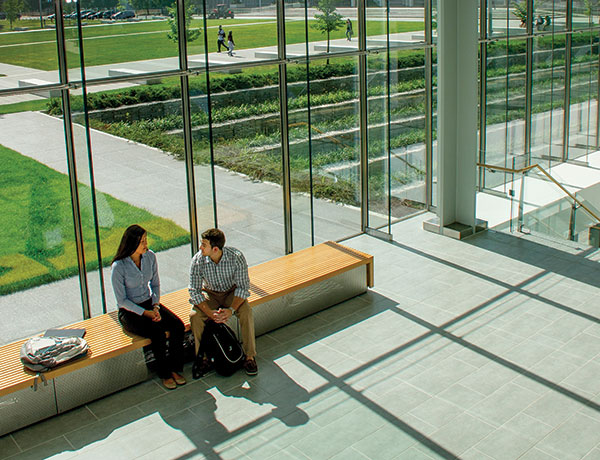 Students chat inside the Massry Center for Business