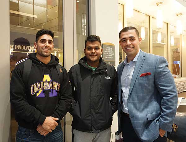 Jamal Rasoully poses for photo with recent alumni and current students