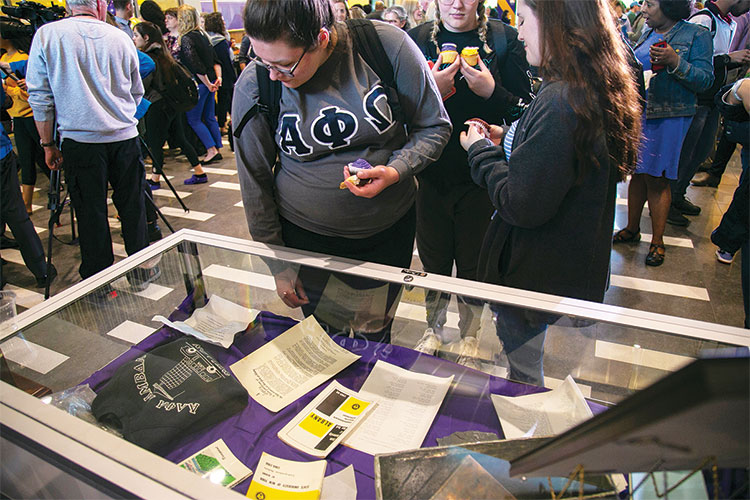 Students inspect contents of time capsule.