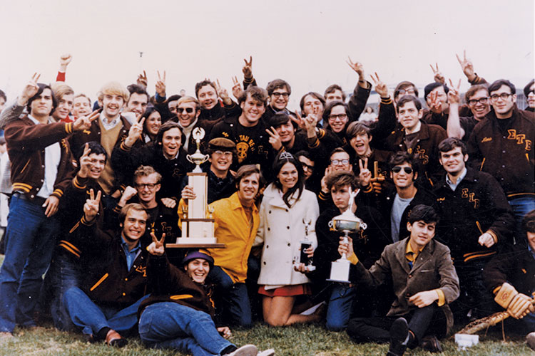 Sigma Tau Beta members hold trophies.