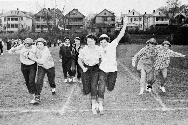 Women run in three legged race.