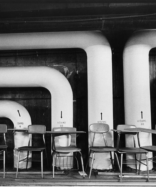 Empty desks and chairs in the tunnel.