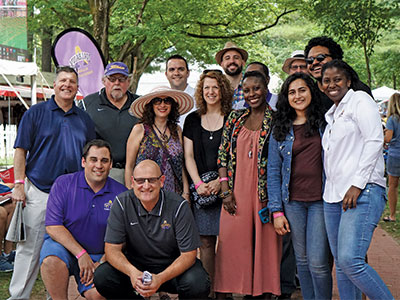 A group of alumni gather at UAlbany Day at the Races event in Saratoga Springs.