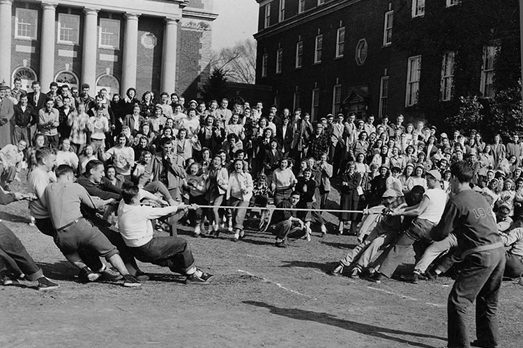 Students look on as teams compete in tug of war competition.