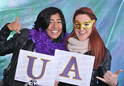 Alumni pose in the Homecoming photobooth