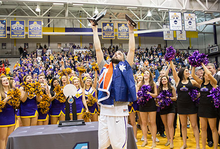 Peter Hooley raises trophy, wears flag after winning America East Championship game