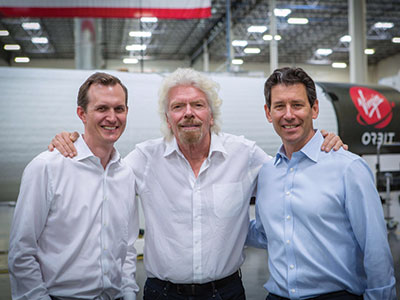 Dan Hart poses for a picture with George Whitesides and Richard Branson