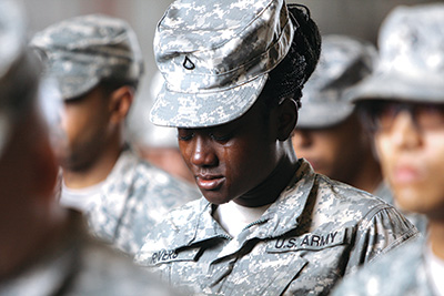 Women soldier with the U.S. Army weeping during prayer