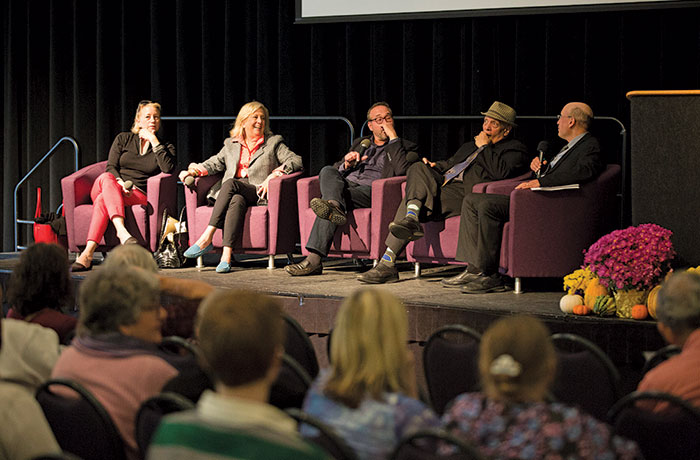 Best selling mystery writers participate in panel discussion on stage.