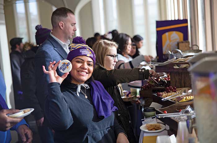 A student shows off a Unleashing Greatness cookie