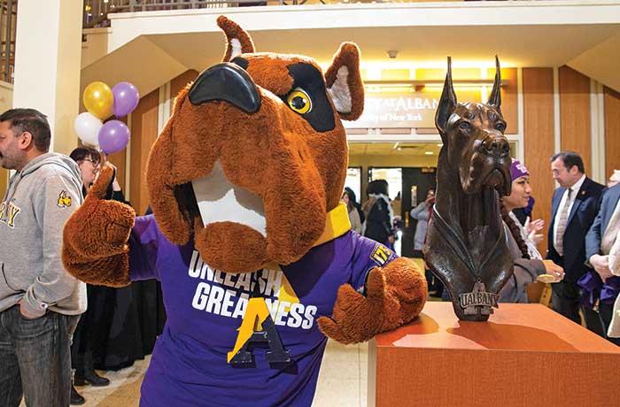 Damien the mascot and the new bronze statue of Damien's head