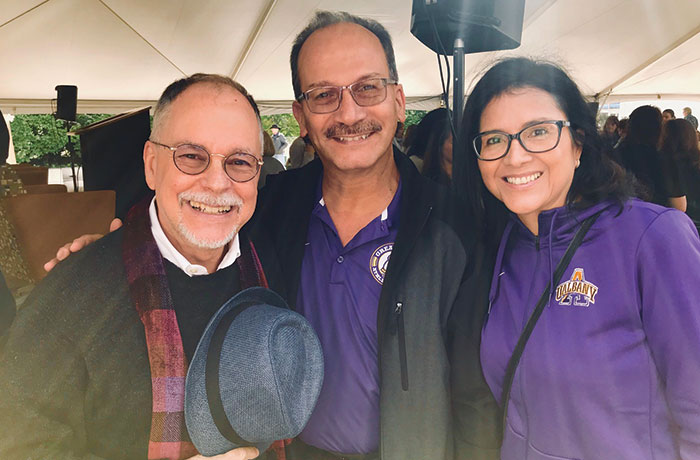 Gregory Maguire takes a picture with President Rodriguez and his wife Rosy