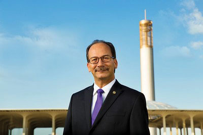 President Havidan Rodriguez stands in front of the carillon on UAlbany's uptown campus