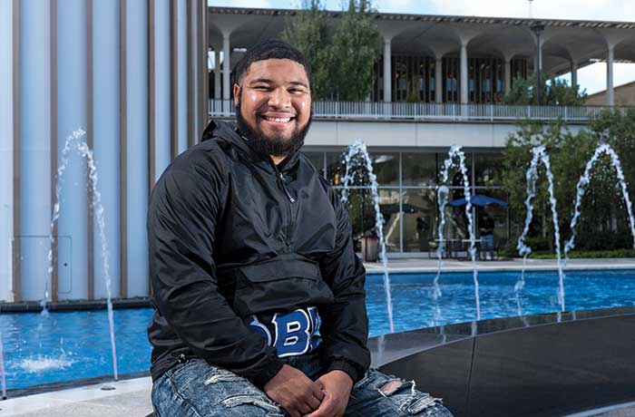 Moises Urena poses for a photo near the Carillon at the main fountain of UAlbany