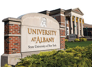 Sign for the University at Albany in front of Rockefeller College