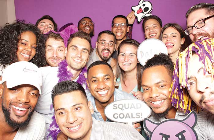 UAlbany Alumni pose for a picture in a photobooth at the GOLD Schmooze