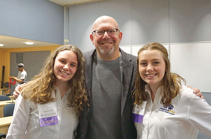 Marc Guggenheim takes a photo with two UAlbany students after an event