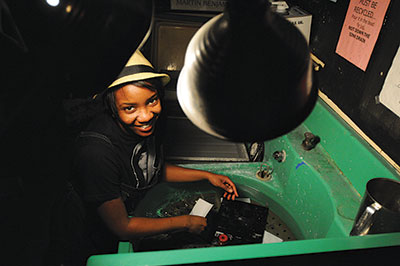 Elian works in the Photo Service darkroom as a student at UAlbany