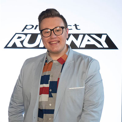 Russo stands in front of Project Runway backdrop