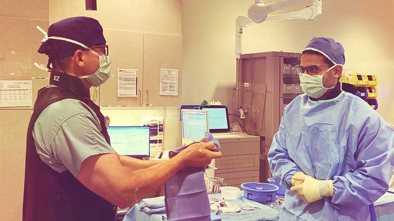 Two doctors talk in the operating room.