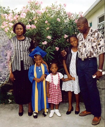 Frederick and her family outside their house in Antigua