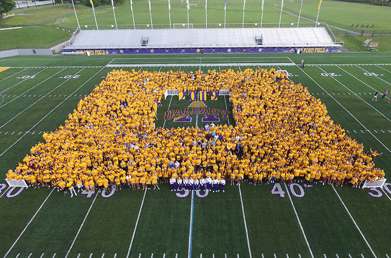 Class of 2019 poses for a photo on the football field last fall